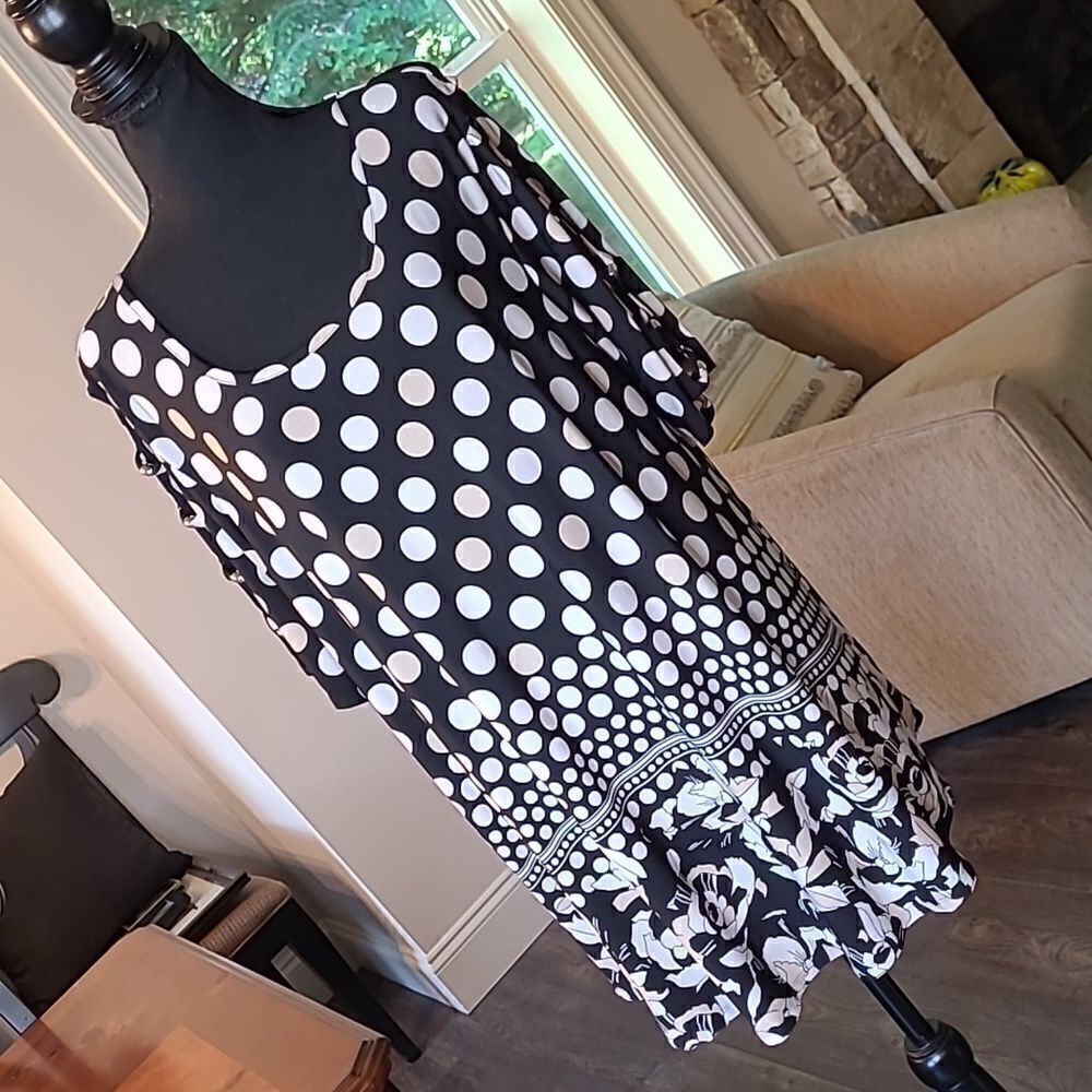 Black with cream polkadots with floral detailing around hem.  Peekaboo sleeves